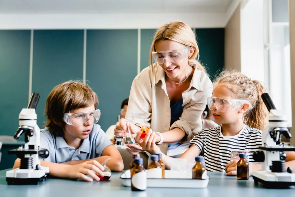 Teacher guiding students during an interactive hands-on learning science session