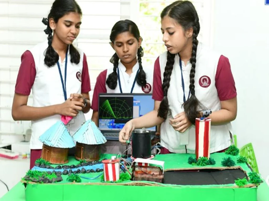 Students demonstrating STEM innovation projects at a school science fair
