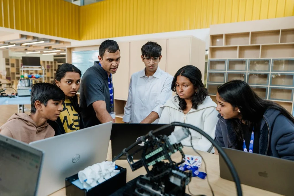 Teacher mentoring students in an applied science and technology innovation lab
